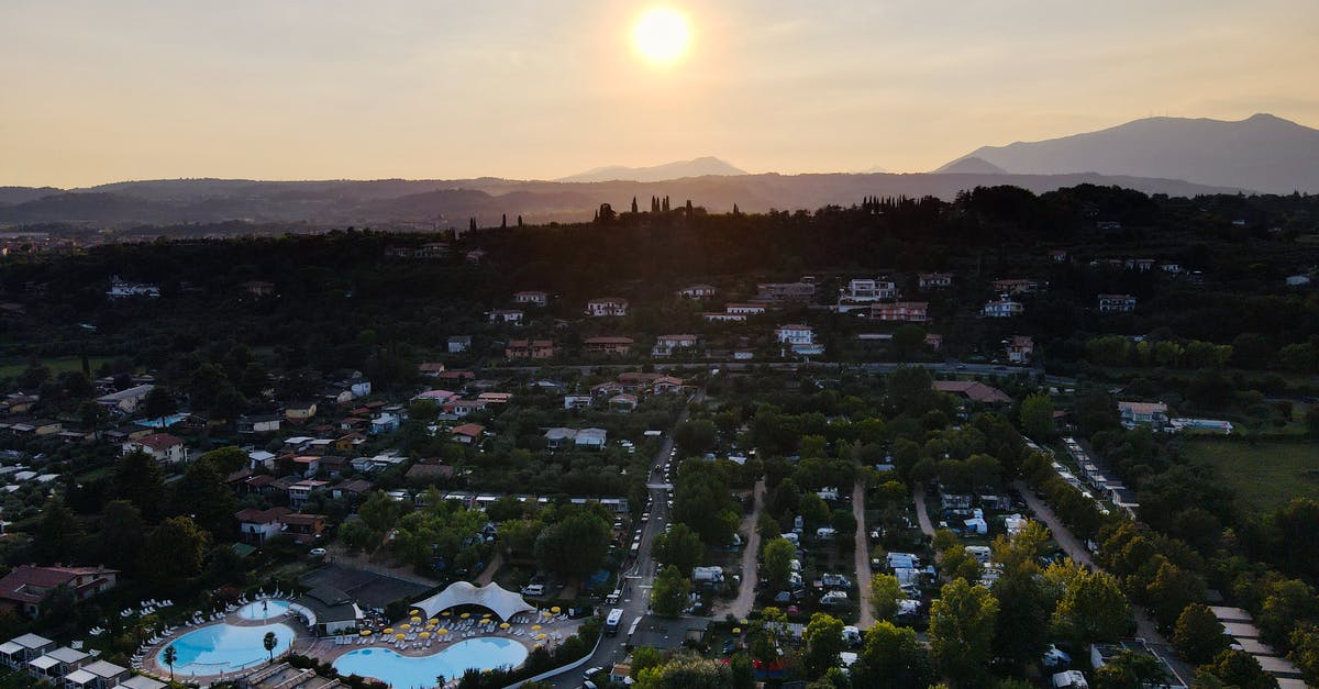 What are the rules for changing after swimming in appartment complex pool in US [closed] - Cottages near trees and mounts under sky with shiny sun
