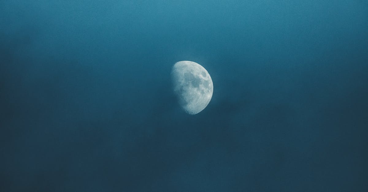 What are these mysterious craters? - Waxing white moon with gray spots illuminating on foggy sky at bright night What are these mysterious craters? - Waxing white moon with gray spots illuminating on foggy sky at bright night