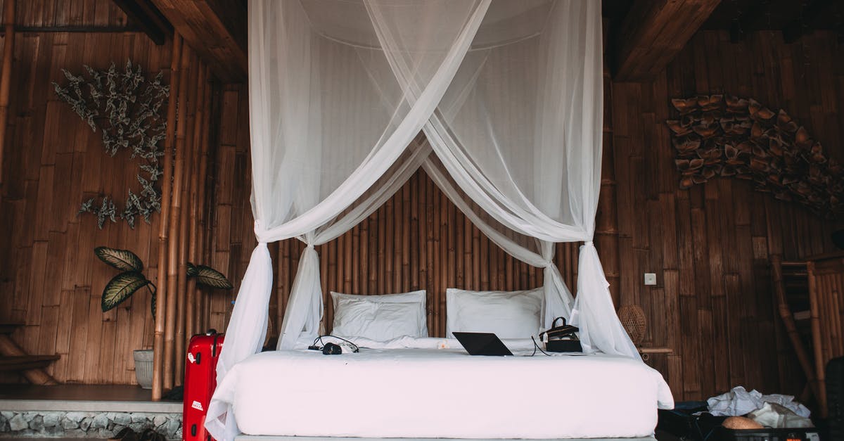 What baggage allowance does 1 PC mean? - Cozy hotel bed with laptop under canopy What baggage allowance does 1 PC mean? - Cozy hotel bed with laptop under canopy