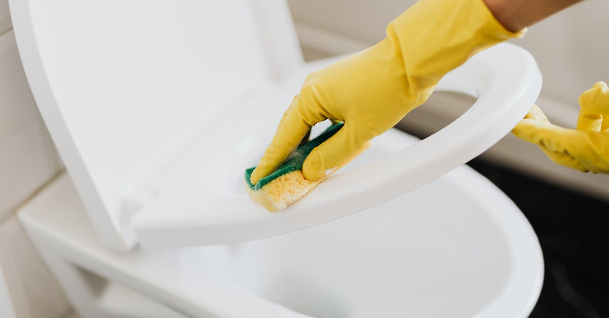 What can I do if I'm seated next to a person with bad hygiene on an airplane? - Crop person cleaning toilet seat with sponge What can I do if I'm seated next to a person with bad hygiene on an airplane? - Crop person cleaning toilet seat with sponge