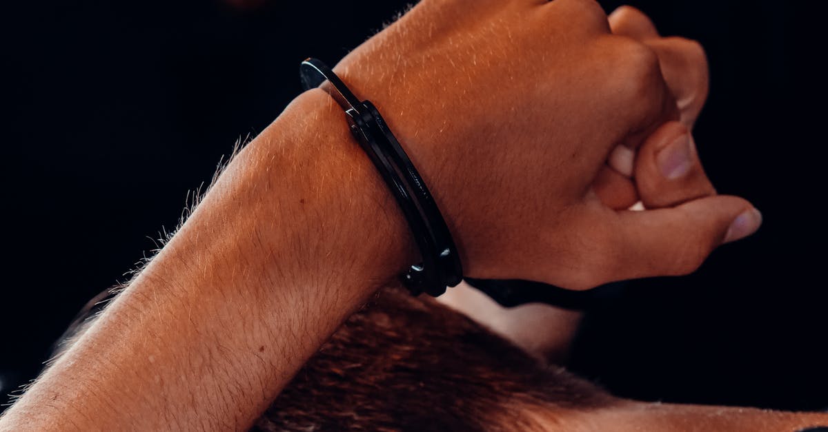 What can security officials do when they suspect my checked baggage? - Hand of a Person with Handcuffs