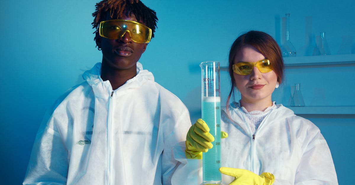 What chemical / solution / reagent are TSA agents using when they test liquids? - A Man and a Woman Looking at the Camera While Holding a Big Graduated Cylinder What chemical / solution / reagent are TSA agents using when they test liquids? - A Man and a Woman Looking at the Camera While Holding a Big Graduated Cylinder