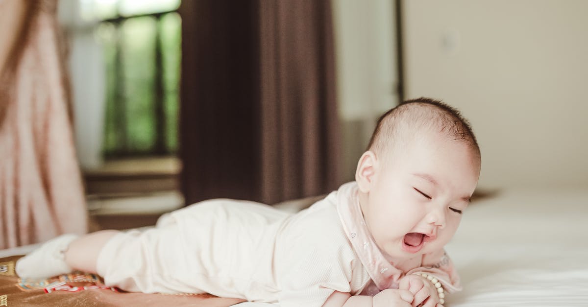 What citizenship/place of birth would a child born on an airplane have? - Cute Asian newborn baby lying on white blanket