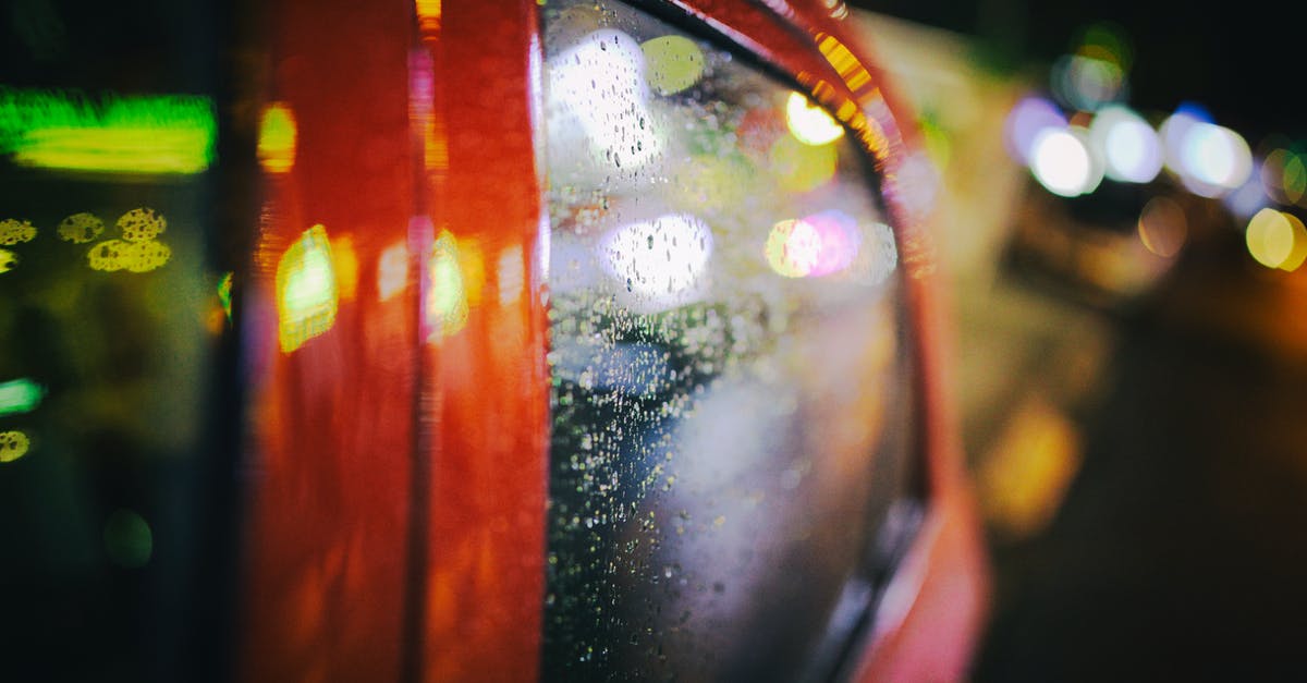 What do I need to have for 12 hours stopover with a small trip to Kiev city? [closed] - Vehicle with wet glass on night street with glowing lights