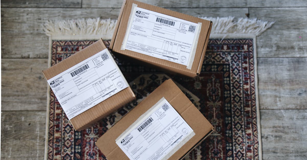 What document will be needed to visit UK? - Brown Cardboard Box on Red and Brown Floral Area Rug