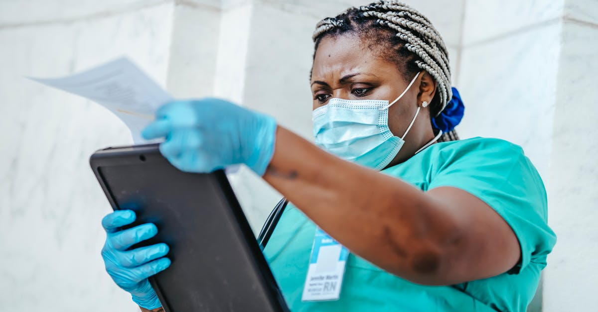 What documents do Irish border control require? - Low angle of focused black female nurse in mask and gloves standing in hospital and looking through papers What documents do Irish border control require? - Low angle of focused black female nurse in mask and gloves standing in hospital and looking through papers