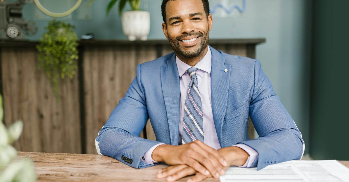 What documents should I submit after refusal of a visit visa? - Smiling Man in Blue Suit Sitting by the Table What documents should I submit after refusal of a visit visa? - Smiling Man in Blue Suit Sitting by the Table