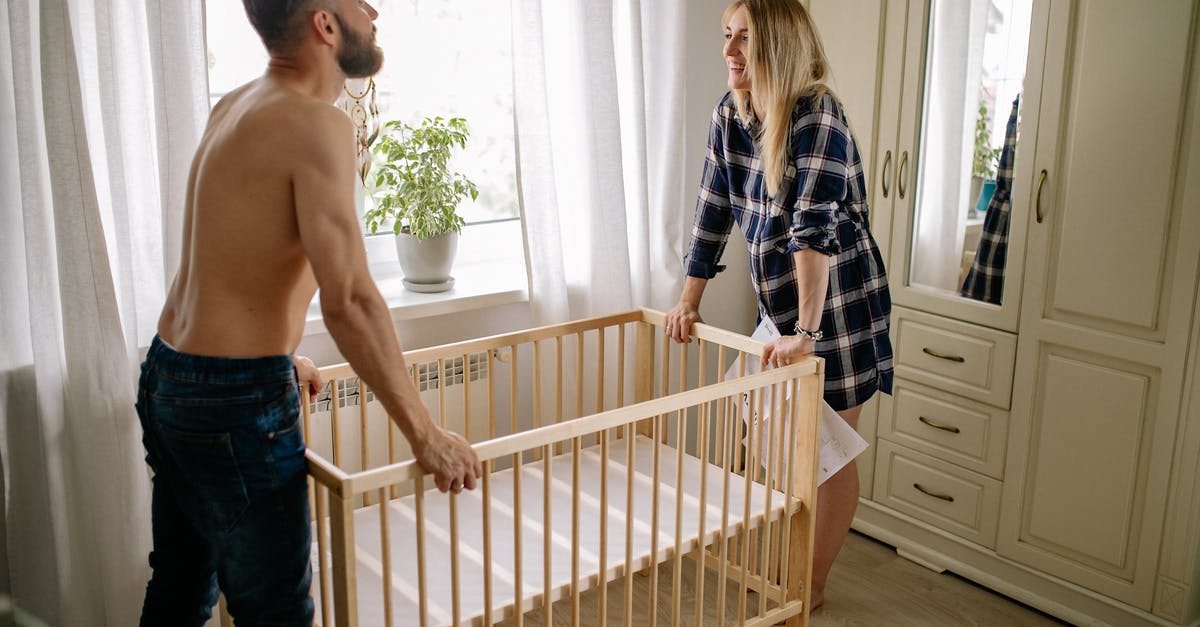 What does a Newborn baby need for a USA visa application? - Happy Couple Assembling Baby Crib at Home What does a Newborn baby need for a USA visa application? - Happy Couple Assembling Baby Crib at Home