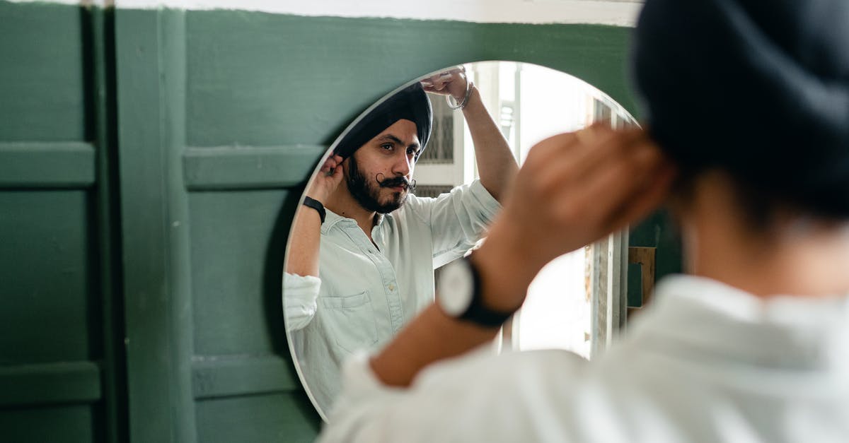What does a Sri Lankan visa for Indians look like? - Back view of Indian man with beard wearing turban and looking in mirror while standing in front of mirror in modern bathroom What does a Sri Lankan visa for Indians look like? - Back view of Indian man with beard wearing turban and looking in mirror while standing in front of mirror in modern bathroom