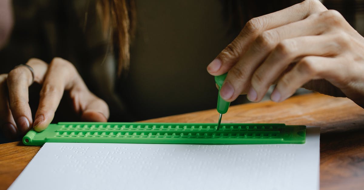 What does the letter code on a UK biometric residence permit indicate? [closed] - Crop anonymous person with vision loss writing braille letter with slate and stylus