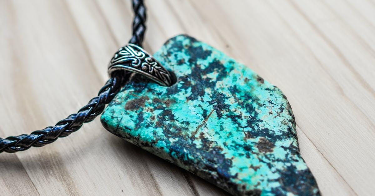 What etiquette, if any, is there for where the knot goes when wearing a yukata or kimono? - Grey and Black Stone Pendant on Black Necklace