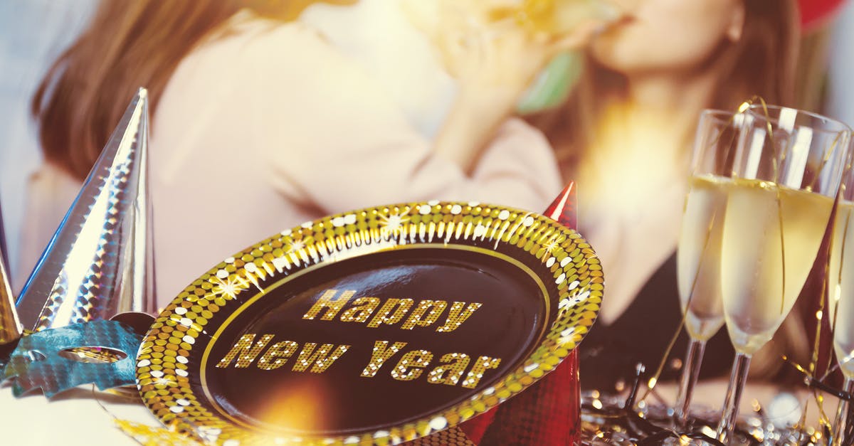 What goes on in Amsterdam during New Year's Eve? - New Year party supplies on table with women drinking champagne What goes on in Amsterdam during New Year's Eve? - New Year party supplies on table with women drinking champagne