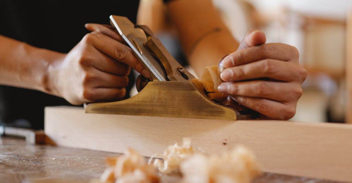 What happens if someone dies on board a plane? - Crop man shaping wood with hand plane in workshop What happens if someone dies on board a plane? - Crop man shaping wood with hand plane in workshop