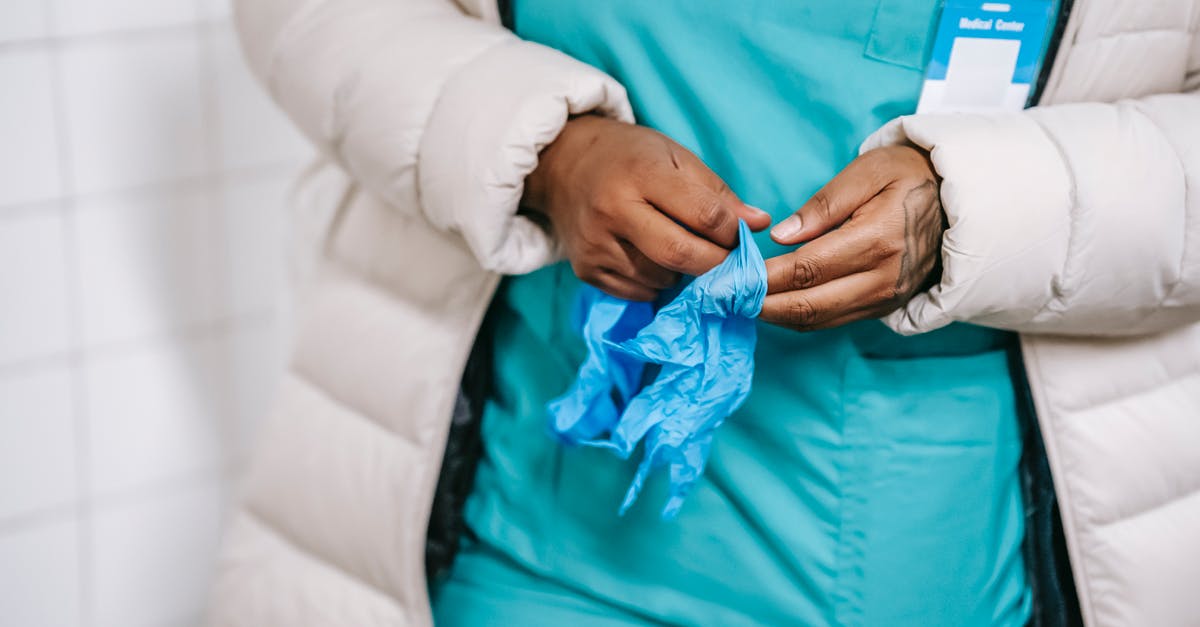 What happens if you have a medical emergency after deplaning but before passing passport control? - Crop ethnic woman dressing up gloves What happens if you have a medical emergency after deplaning but before passing passport control? - Crop ethnic woman dressing up gloves