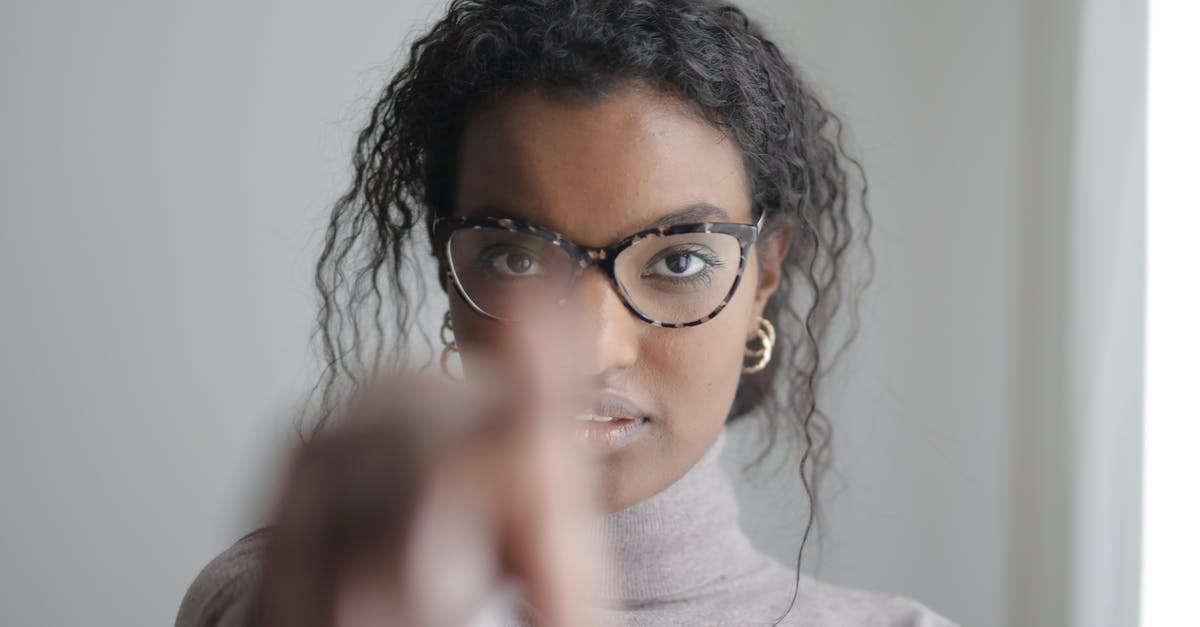 What happens to reward points/miles when you are rebooked? - Young ethnic woman pointing at camera What happens to reward points/miles when you are rebooked? - Young ethnic woman pointing at camera