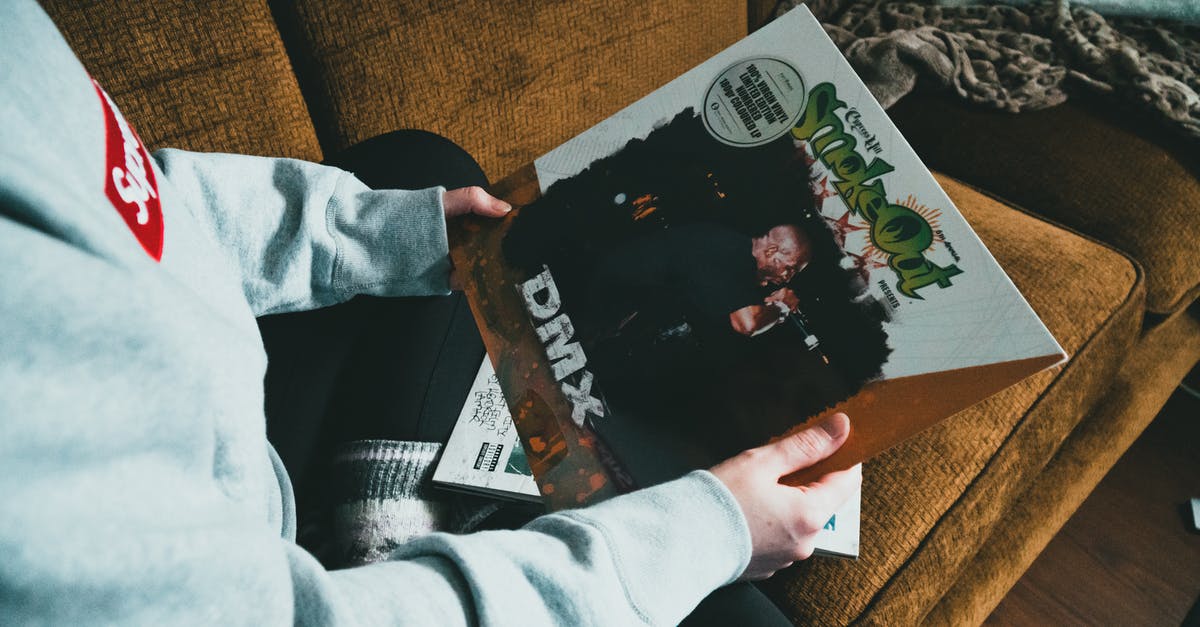 What happens to the immigration record of a person being evacuated/airlifted by their embassy from another country? - Person sitting on sofa and showing vinyl record in cover