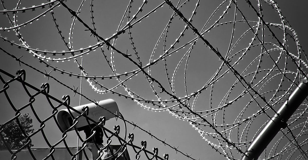 What Hours Are Newark Airport's Security Lines Open? - Grayscale Photo of Barbed Wire