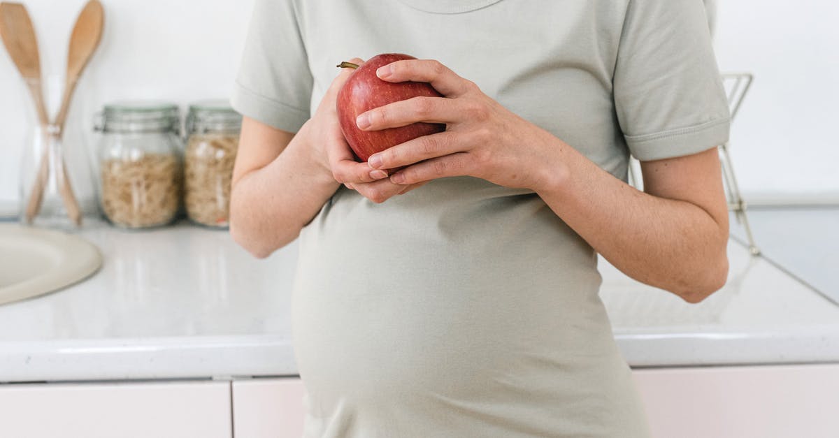 What, if any, immigration controls can be expected on a domestic flight within the UK? - Unrecognizable pregnant female with ripe red apple for healthy diet in hands standing near counter in light kitchen at home What, if any, immigration controls can be expected on a domestic flight within the UK? - Unrecognizable pregnant female with ripe red apple for healthy diet in hands standing near counter in light kitchen at home
