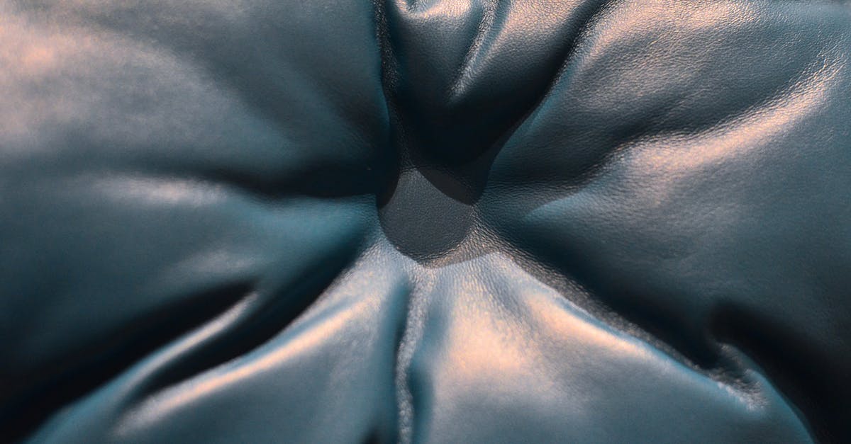 What if buses had bench-style seating? [closed] - Closeup of black leather couch with carriage coupler and button with light glares placed in light room in cozy flat