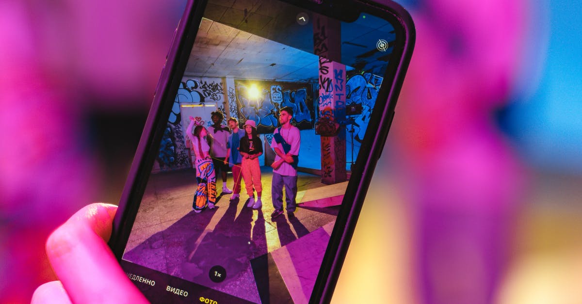 What immigration lane do I use as a group? [closed] - Close-Up Shot of a Person Taking Photo Using a Smartphone
