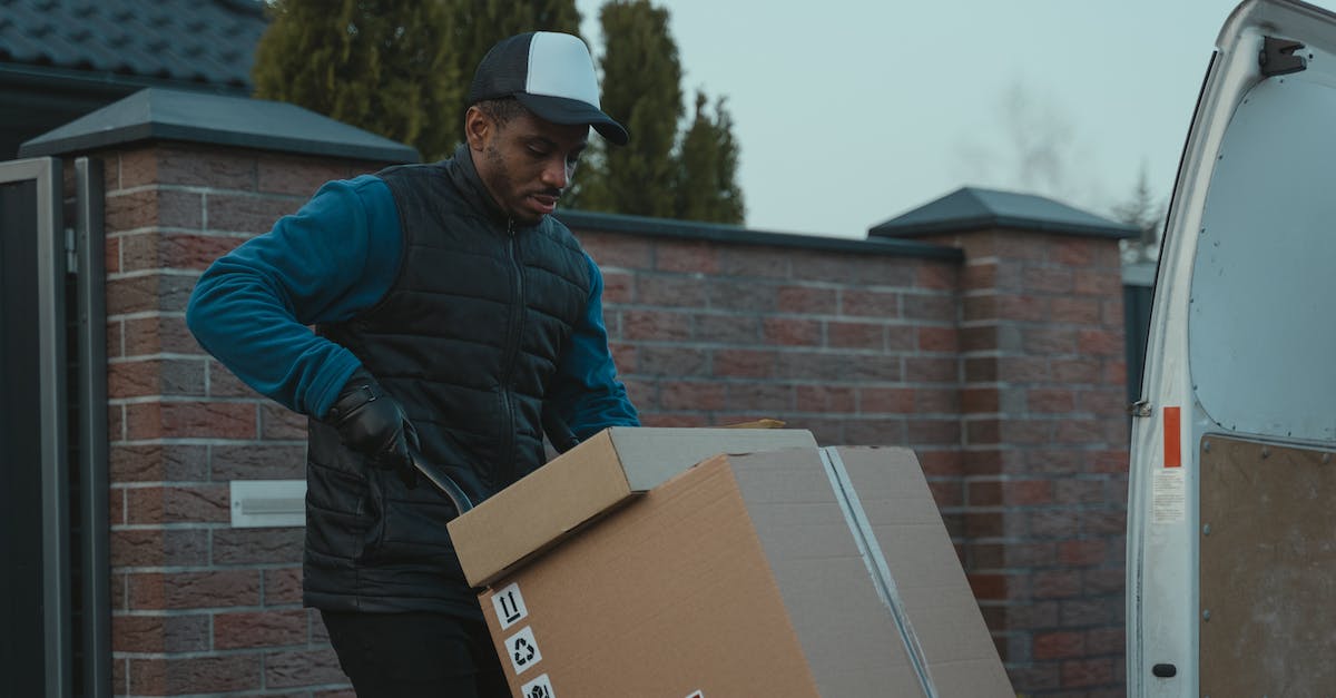 What is a good town/place to stay at, in order to visit the Dead Sea? - Man in Blue Jacket and Black Cap Holding Brown Cardboard Box What is a good town/place to stay at, in order to visit the Dead Sea? - Man in Blue Jacket and Black Cap Holding Brown Cardboard Box