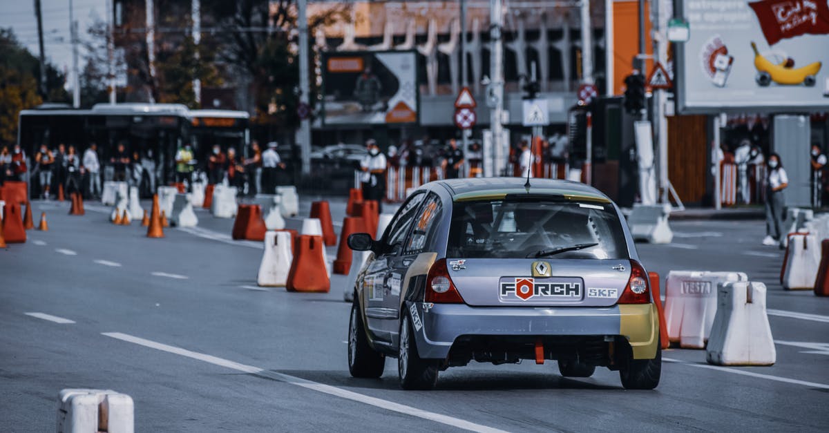 What is a good way to find new western friends in a foreign city? [closed] - Modern silver car driving on street with traffic cones