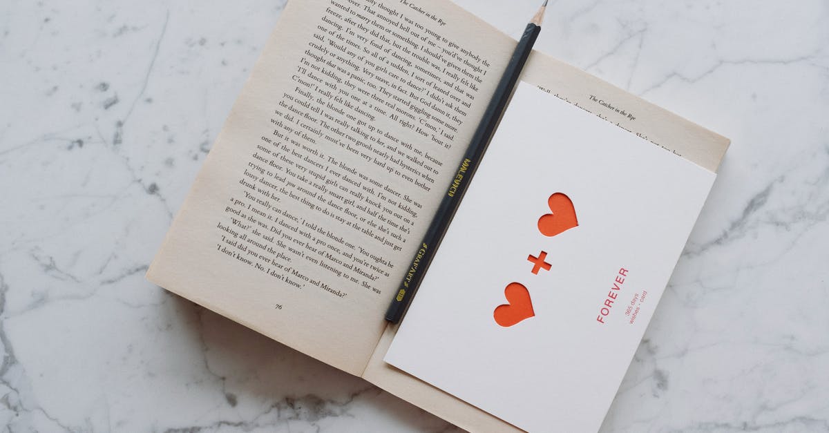 What is a "Partially open bathroom"? - Top view of opened novel book with pencil and romantic postcard placed on white marble surface What is a "Partially open bathroom"? - Top view of opened novel book with pencil and romantic postcard placed on white marble surface
