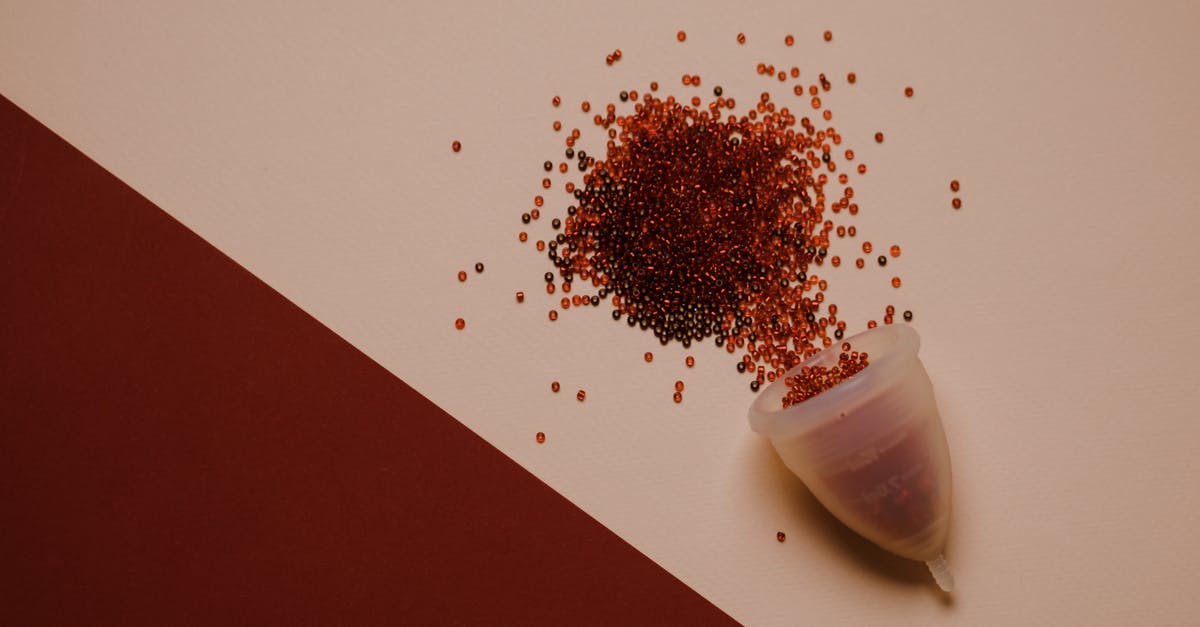 What is an easy alternative to flying to Athens from London? - Top view of silicone menstrual cup with red beads scattered on pink surface What is an easy alternative to flying to Athens from London? - Top view of silicone menstrual cup with red beads scattered on pink surface