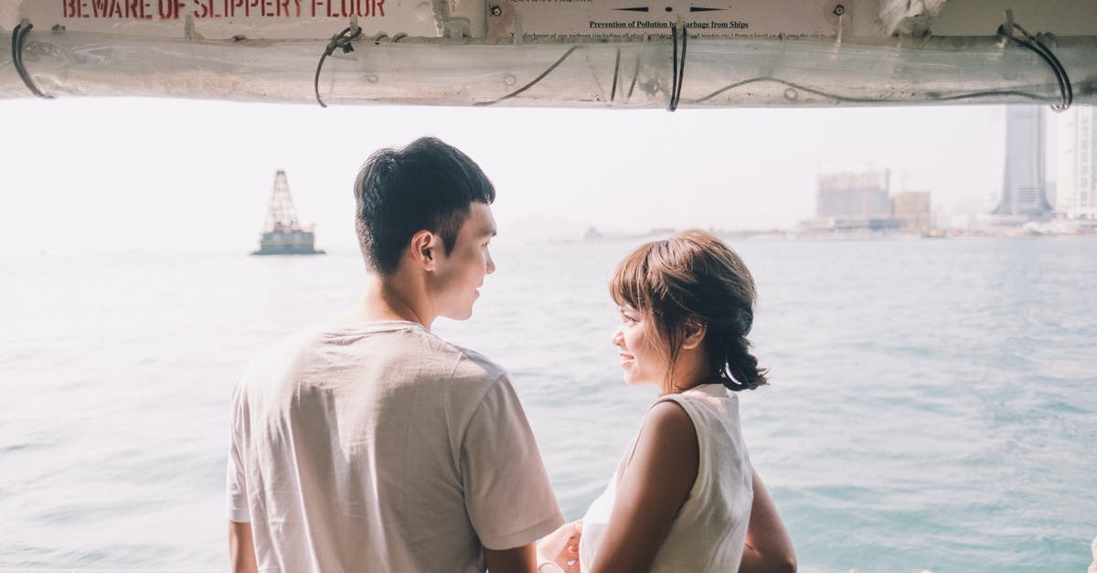 What is the best for a honeymoon destination in August? [closed] - Young Asian couple standing on yacht
