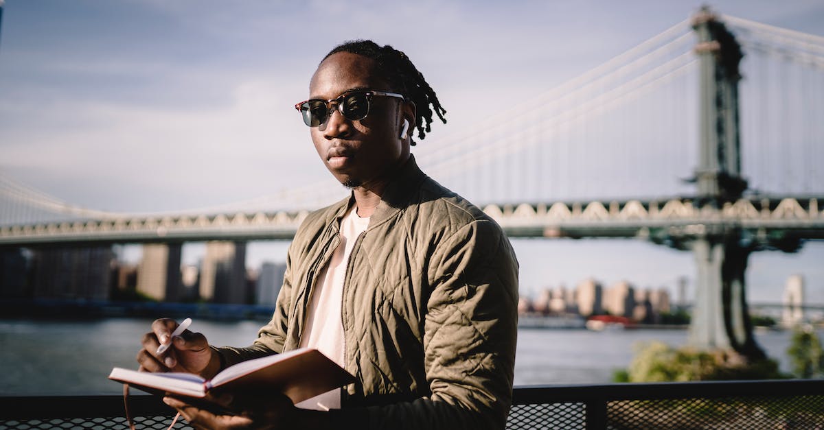 What is the best self-guided itinerary for an 8-day trip to Scotland in April? [closed] - Serious African American man planning route standing on river embankment
