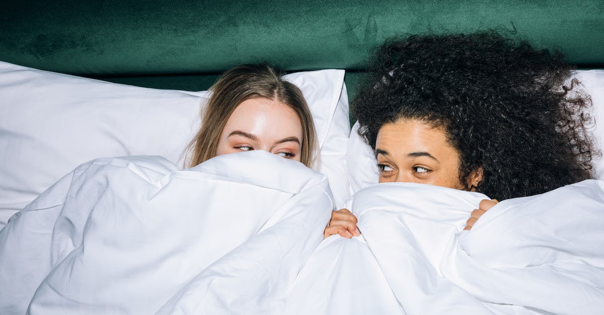 What is the best time to see the Lavender in France? - Two Young Women Lying on White Bed While Looking at Each Other What is the best time to see the Lavender in France? - Two Young Women Lying on White Bed While Looking at Each Other