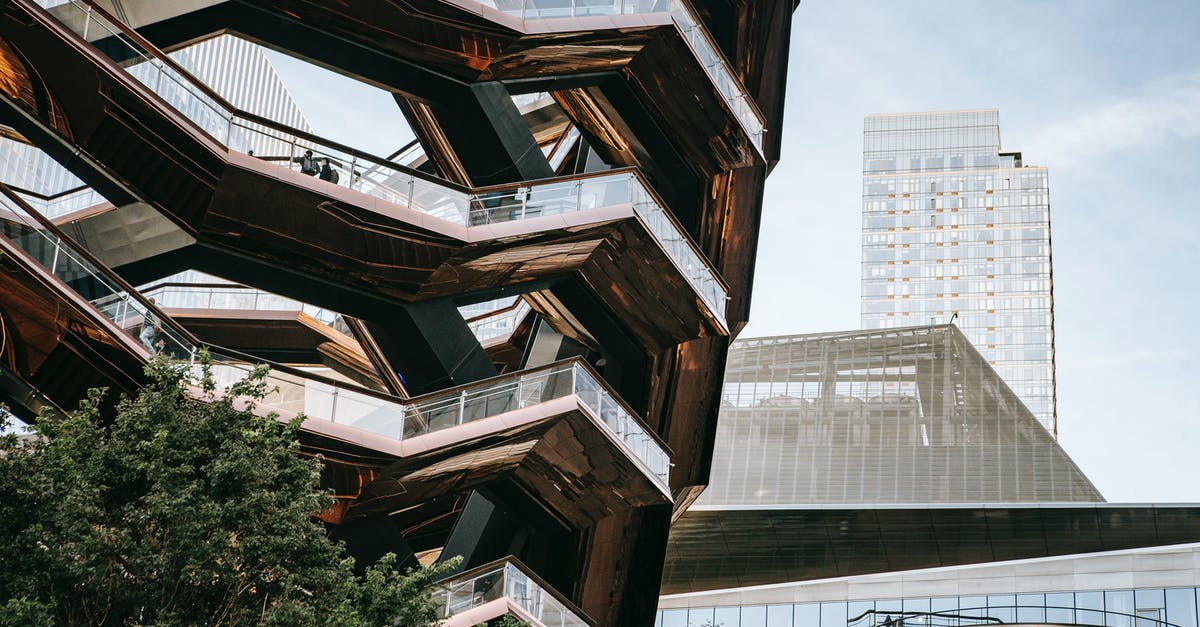 What is the cheapest form of public transportation from Amsterdam to Northern Ireland? - Low angle of futuristic geometric construction with stairs above bushes in city with skyscrapers in daylight What is the cheapest form of public transportation from Amsterdam to Northern Ireland? - Low angle of futuristic geometric construction with stairs above bushes in city with skyscrapers in daylight