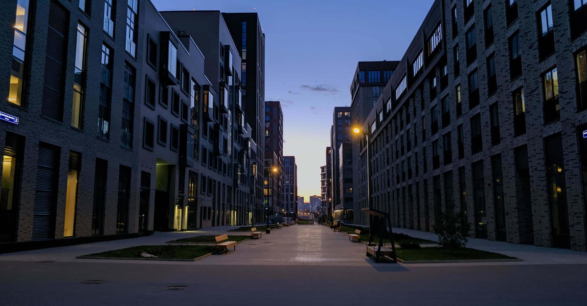 What is the cheapest way of travelling between New York and Las Vegas by public transportation? [closed] - Empty pedestrian street with benches between stylish modern geometric buildings against sunrise sky