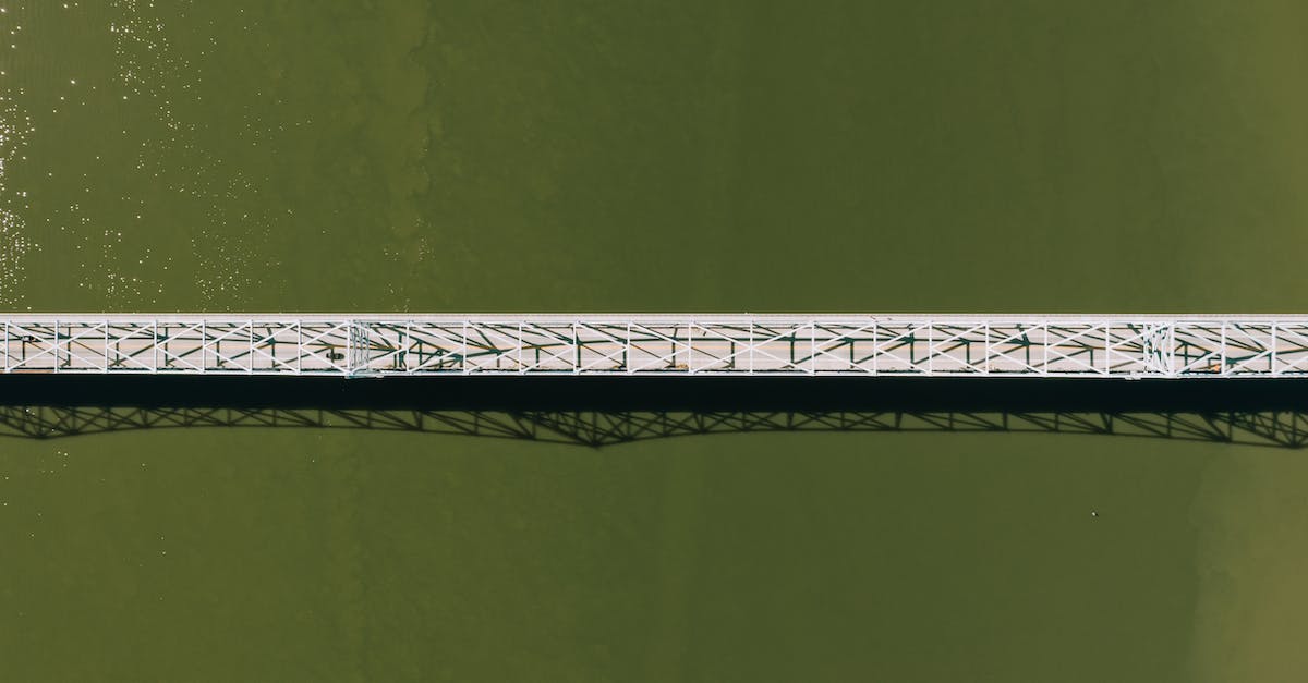 What is the cheapest way to cross the English Channel from France to the UK on foot, single ticket? - Aerial top view of modern motor bridge crossing vast rippling river on sunny day What is the cheapest way to cross the English Channel from France to the UK on foot, single ticket? - Aerial top view of modern motor bridge crossing vast rippling river on sunny day
