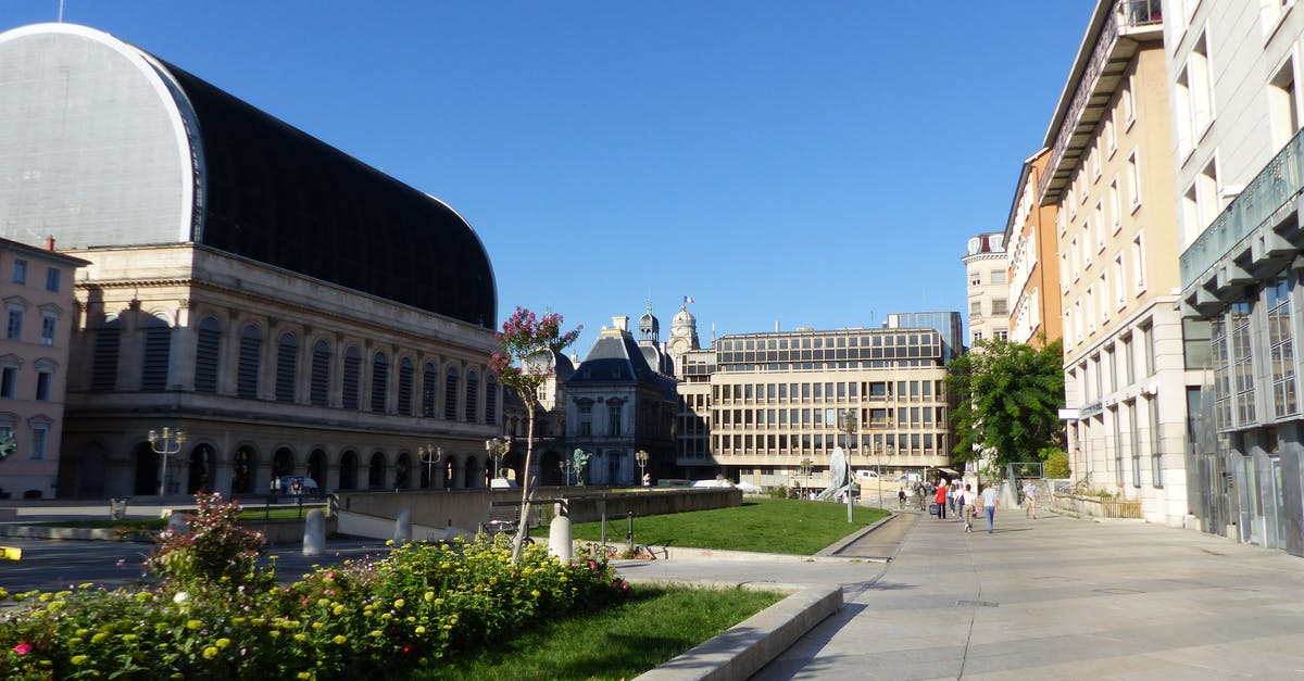 What is the city center of Lyon in France so we don't book too far? - Exterior of aged Opera House and classic styled building located on square against cloudless blue sky in Lyon What is the city center of Lyon in France so we don't book too far? - Exterior of aged Opera House and classic styled building located on square against cloudless blue sky in Lyon