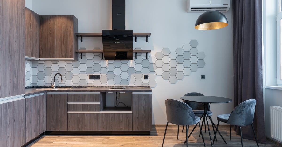 What is the Difference Between Air Conditioning and Climate Control? - Modern kitchen interior with furniture and lamp at home What is the Difference Between Air Conditioning and Climate Control? - Modern kitchen interior with furniture and lamp at home
