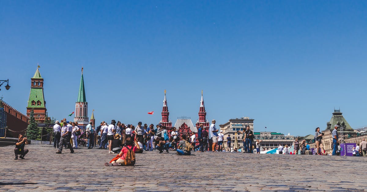What is the impact in travel history after visiting Russian federation? can i apply for Schengen? - People Walking On A City Square Under Clear Blue Sky