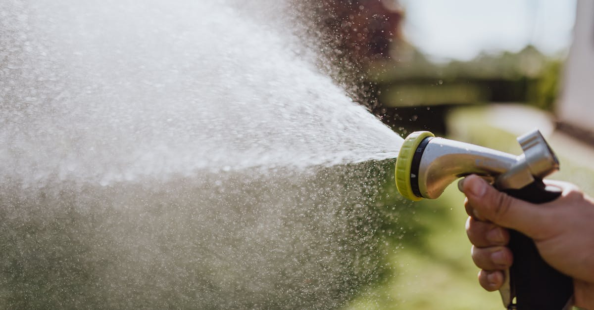 What is the intended use of the water hose in Indian restrooms? [duplicate] - Close-Up Photo of a Person Using a Spray Hose