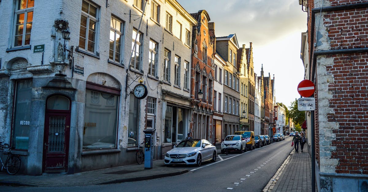 What is the most campsite-dense route between Belgium and the Tatras? - Low angle of asphalt road with parked vehicles near aged residential buildings in historical district of Bruges in sunny morning What is the most campsite-dense route between Belgium and the Tatras? - Low angle of asphalt road with parked vehicles near aged residential buildings in historical district of Bruges in sunny morning