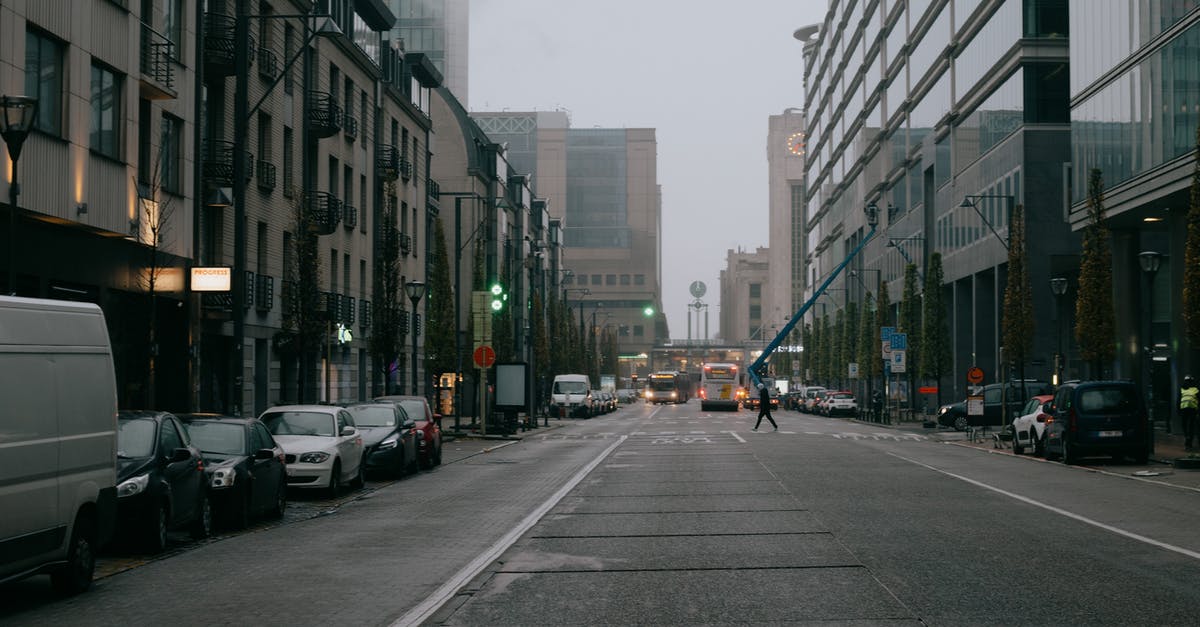 What is the most campsite-dense route between Belgium and the Tatras? - Traffic on city road among buildings on overcast sky What is the most campsite-dense route between Belgium and the Tatras? - Traffic on city road among buildings on overcast sky