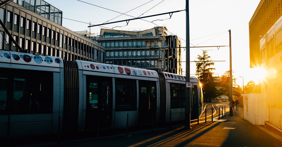 What is the most remote railway line in the world? - Tram riding on railroad on city street in summer in evening time near buildings What is the most remote railway line in the world? - Tram riding on railroad on city street in summer in evening time near buildings