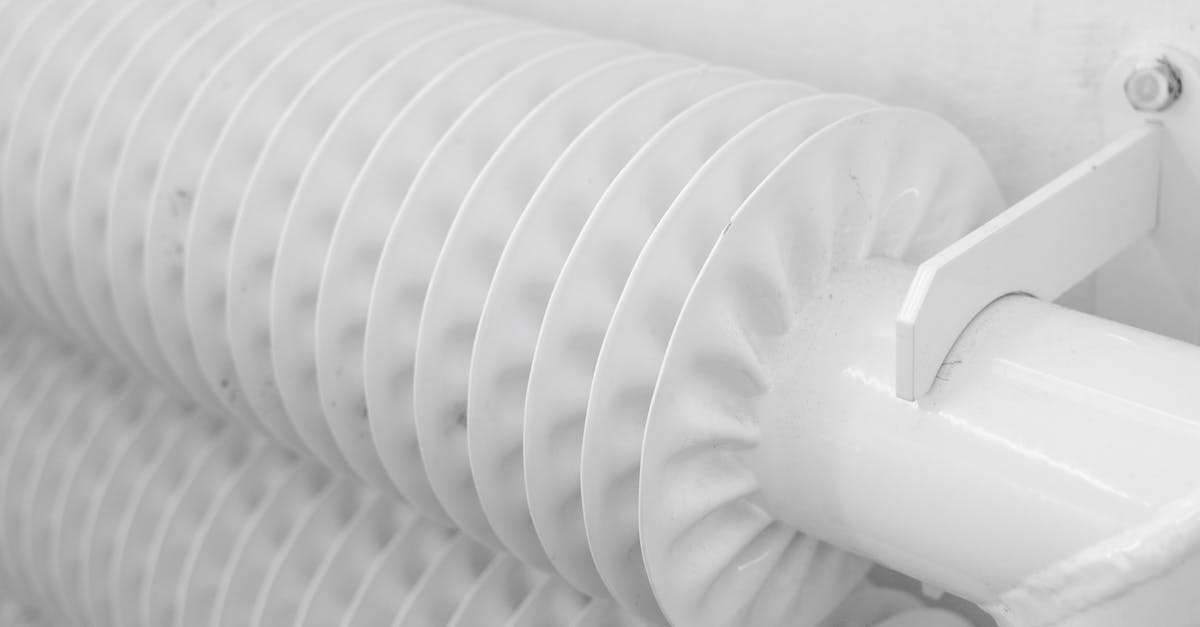 What is the name for the set of the outbound segment and inbound segment together? - White metal tubed radiator system with pipe for industrial heating mounted to wall with hook in light room at home
