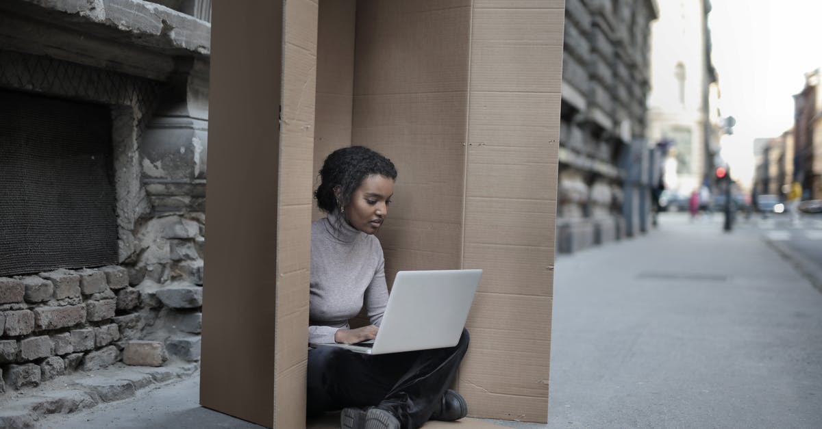 What is the oldest building in the world still in use? - Young female introvert in casual clothes typing on netbook while sitting with crossed legs inside cardboard box located on asphalt road in city in afternoon What is the oldest building in the world still in use? - Young female introvert in casual clothes typing on netbook while sitting with crossed legs inside cardboard box located on asphalt road in city in afternoon