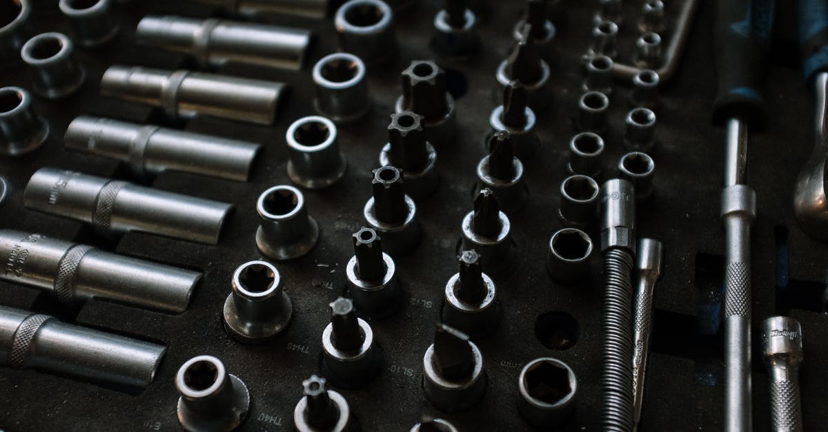 What is the proper tool to unscrew this type of screw? [closed] - Silver and Black Metal Tools