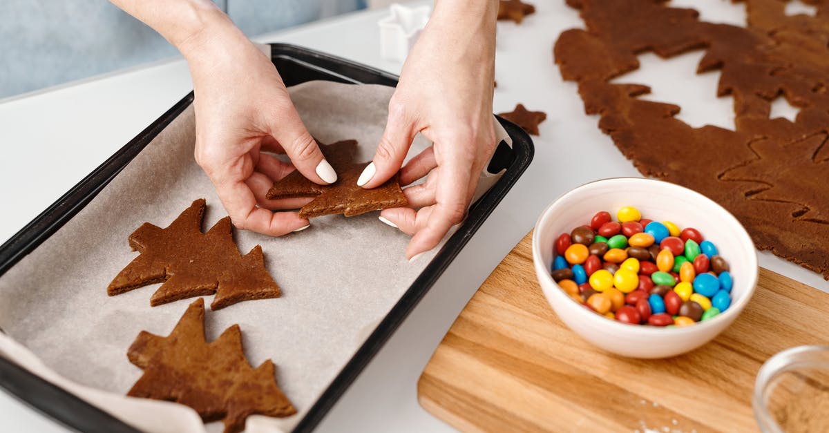 What is the purpose of putting all your gadgets in the trays the TSA provides? - Person Putting Christmas Tree Shaped Cookies on a Tray