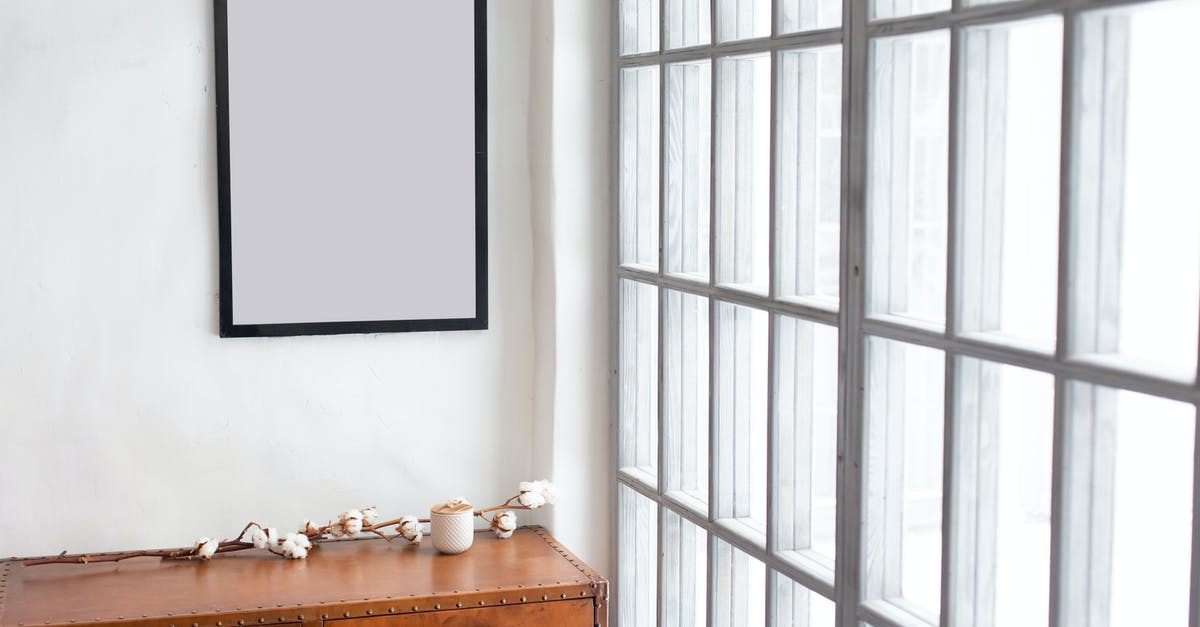 What is the purpose of this wooden rectangular arch shaped construct in Siberia? - Interior of simple room with empty frame near rectangular shaped windows in daytime What is the purpose of this wooden rectangular arch shaped construct in Siberia? - Interior of simple room with empty frame near rectangular shaped windows in daytime