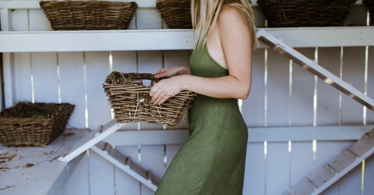 What is the purpose of this wooden rectangular arch shaped construct in Siberia? - Crop woman with basket in wooden coop What is the purpose of this wooden rectangular arch shaped construct in Siberia? - Crop woman with basket in wooden coop