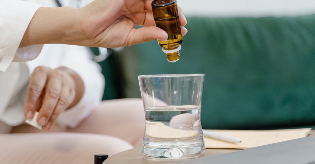 What is the reason for differential treatment between foreign and local customers at Sukiyabashi Jiro? [closed] - Person Holding Clear Drinking Glass With Brown Liquid