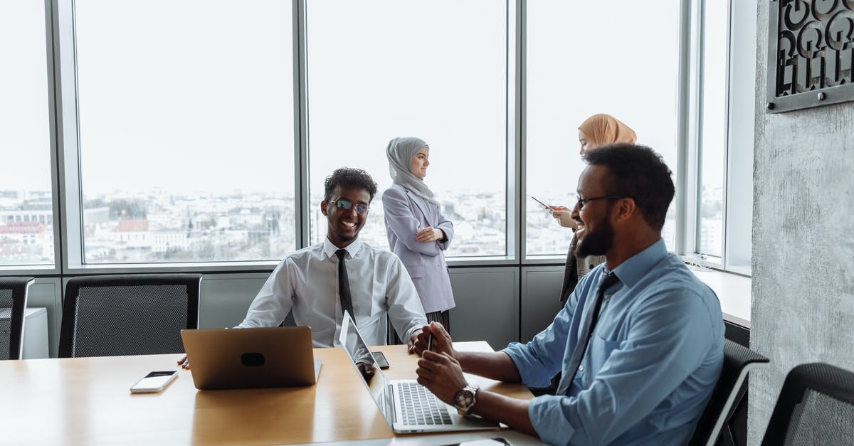 What is the reason to not allow smartphones and laptops in checked baggage? - Smiling Colleagues in a Meeting What is the reason to not allow smartphones and laptops in checked baggage? - Smiling Colleagues in a Meeting