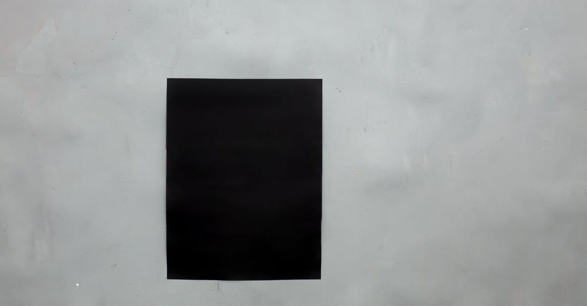 What is the sheet they attach in passport in tax-free shop? [duplicate] - Rectangular creative black mock up poster with copy space hanging on empty gray wall in light room of modern studio